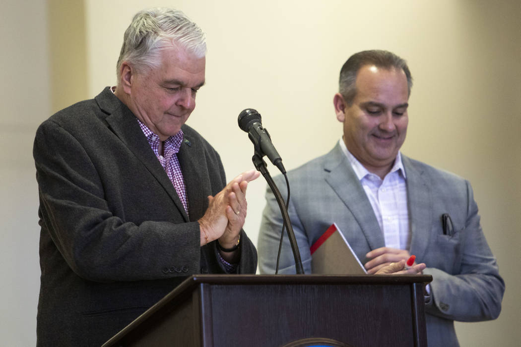 Gov. Steve Sisolak and CCSD Superintendent Jesus Jara use hand sanitizer before announcing that ...