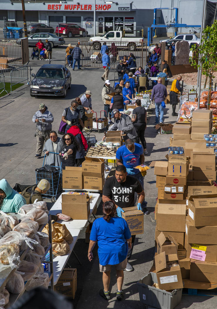 Volunteers and staff distribute food, water and other supplies at SHARE Village Las Vegas on Sa ...