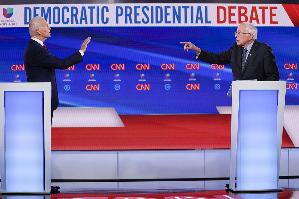 Former Vice President Joe Biden, left, and Sen. Bernie Sanders, I-Vt., right, participate in a ...