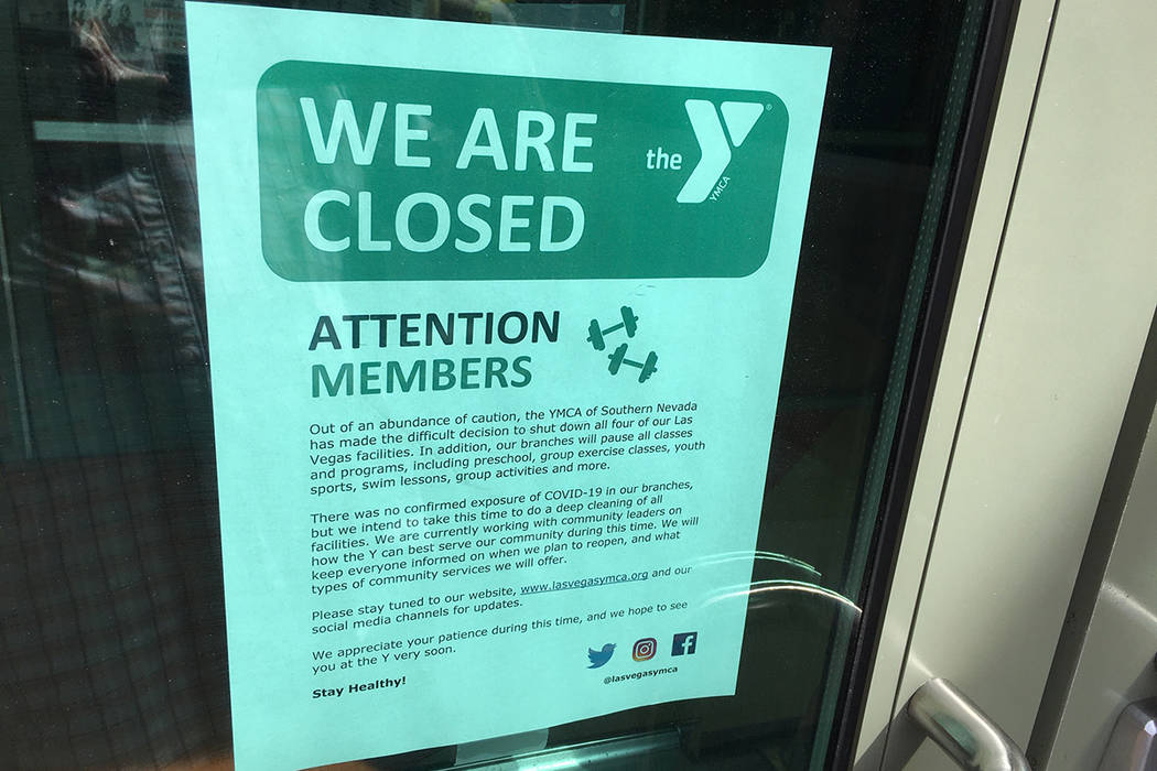 A notice posted on the door of the Centennial YMCA tells patrons about the building's closure. ...