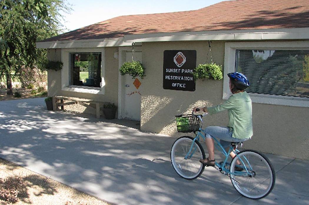 A woman rides a bike at the Sunset Park Reservation office. (Las Vegas Review-Journal)