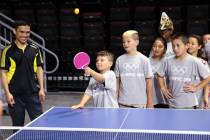 Luciano Sparacio, 8, plays table tennis as coach Jozon Lavilla, left, looks on during Olympic D ...