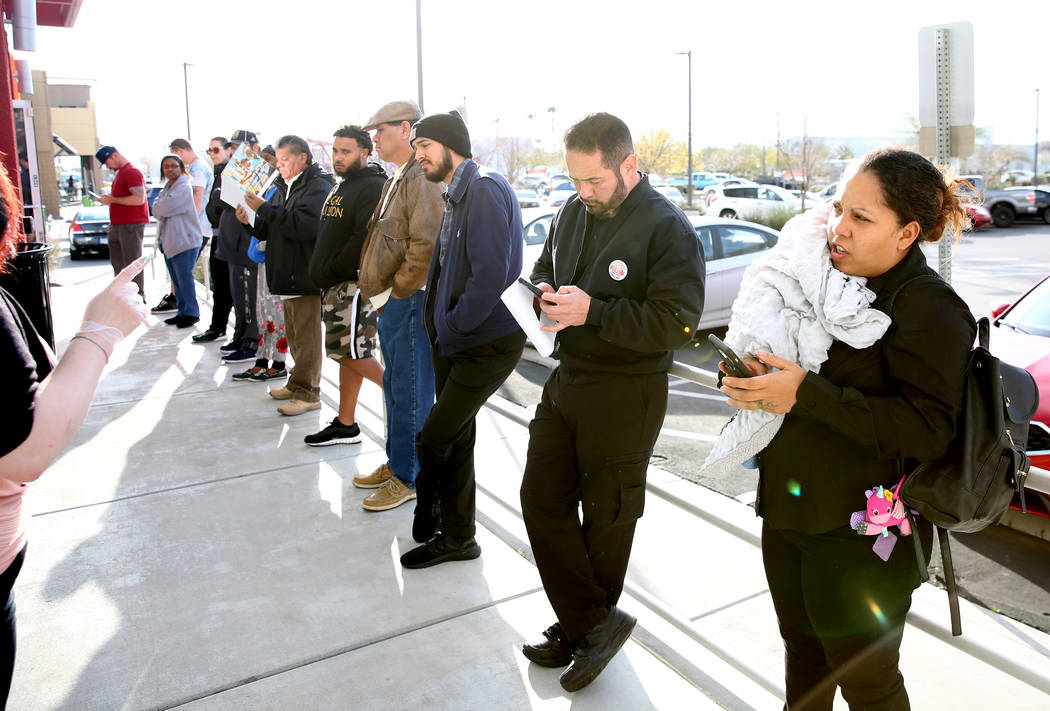 People wait in line at One-Stop Career Center on Monday, March 16, 2020, in Las Vegas. (Bizuaye ...