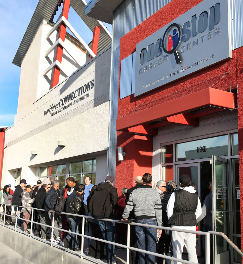 People wait in line at One-Stop Career Center on Monday, March 16, 2020, in Las Vegas. (Bizuaye ...