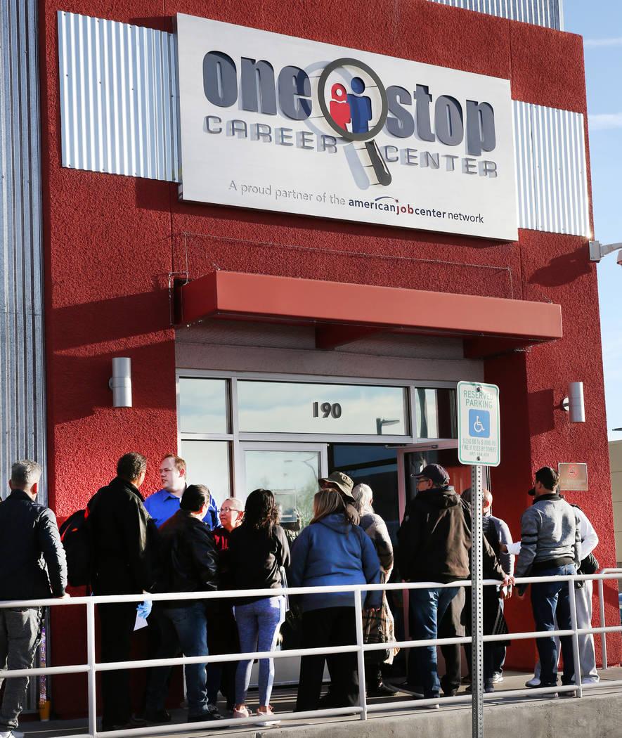 People wait in line at One-Stop Career Center on Monday, March 16, 2020, in Las Vegas. (Bizuaye ...