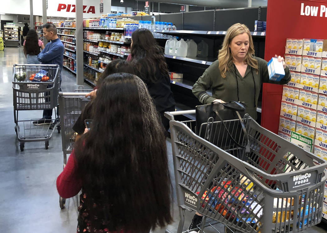 Meg Nelson, right, of Las Vegas shops at WinCo Foods on Monday, March 16, 2020, in Las Vegas. ( ...