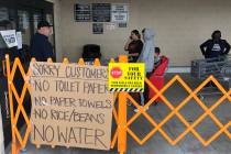 A list of sold out items are posted as customers wait in line at WinCo Foods on Monday, March 1 ...