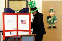 A voter fills out his ballot, taking advantage of early voting, Sunday, March 15, 2020, in Steu ...