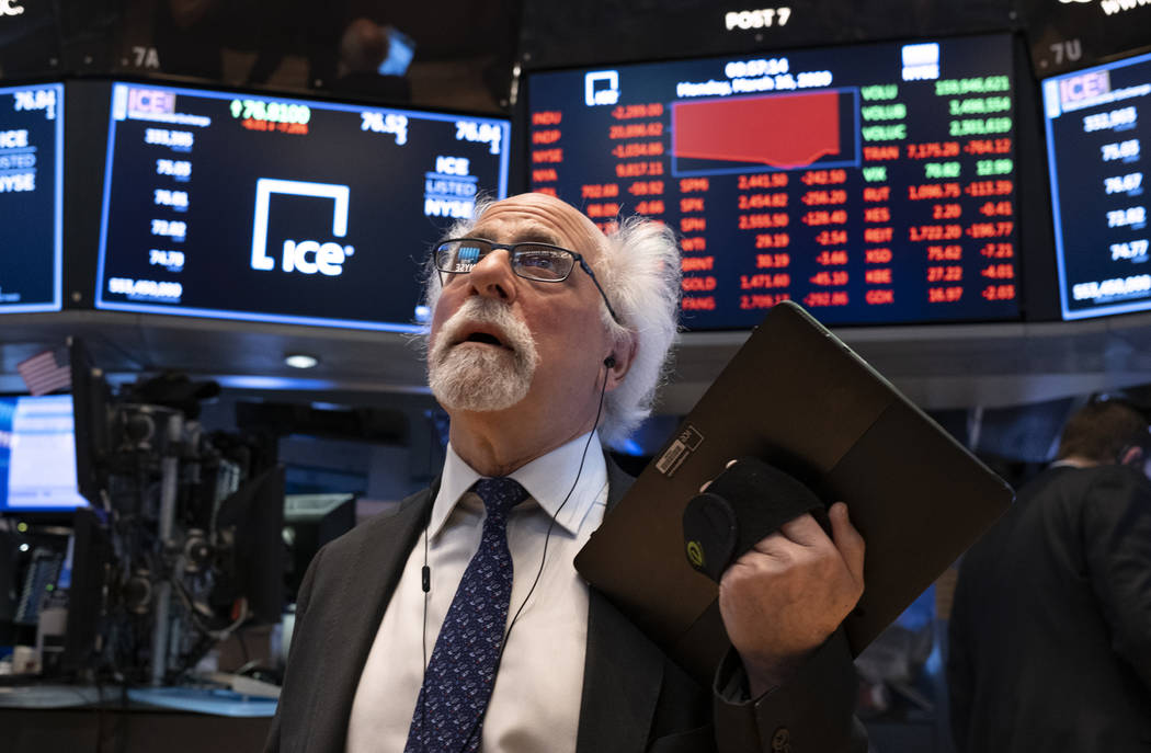 Trader Peter Tuchman works on the floor of the New York Stock Exchange Monday, March 16, 2020. ...