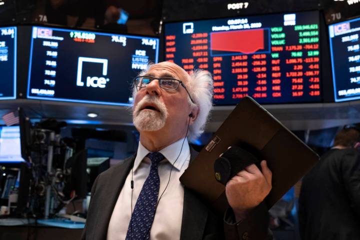 Trader Peter Tuchman works on the floor of the New York Stock Exchange Monday, March 16, 2020. ...