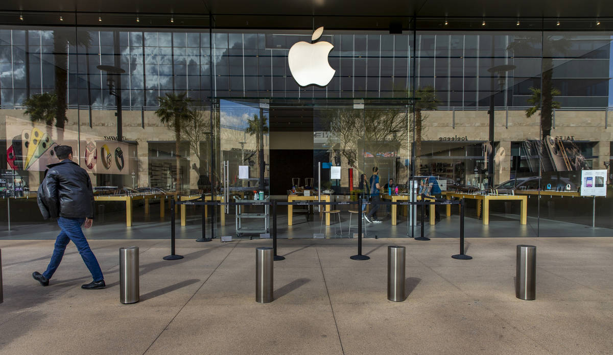 A passerby looks to the Apple Store now closed until March 27th at Downtown Summerlin which has ...