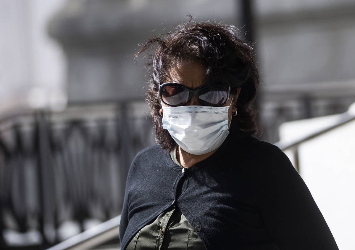 A tourist wearing a medical mask makes their way along the Strip on Tuesday, March 17, 2020, in ...