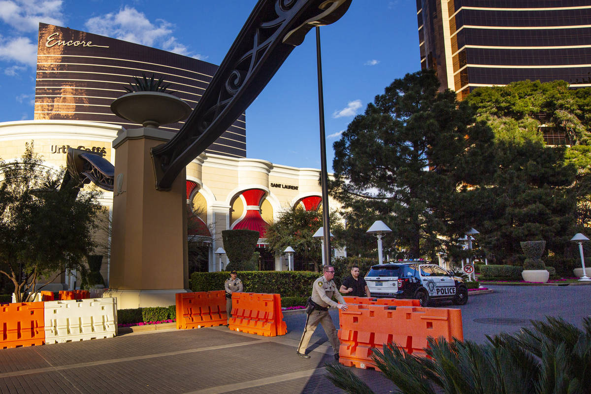 Las Vegas police and security officers at Wynn Las Vegas move barricades out front of the resor ...