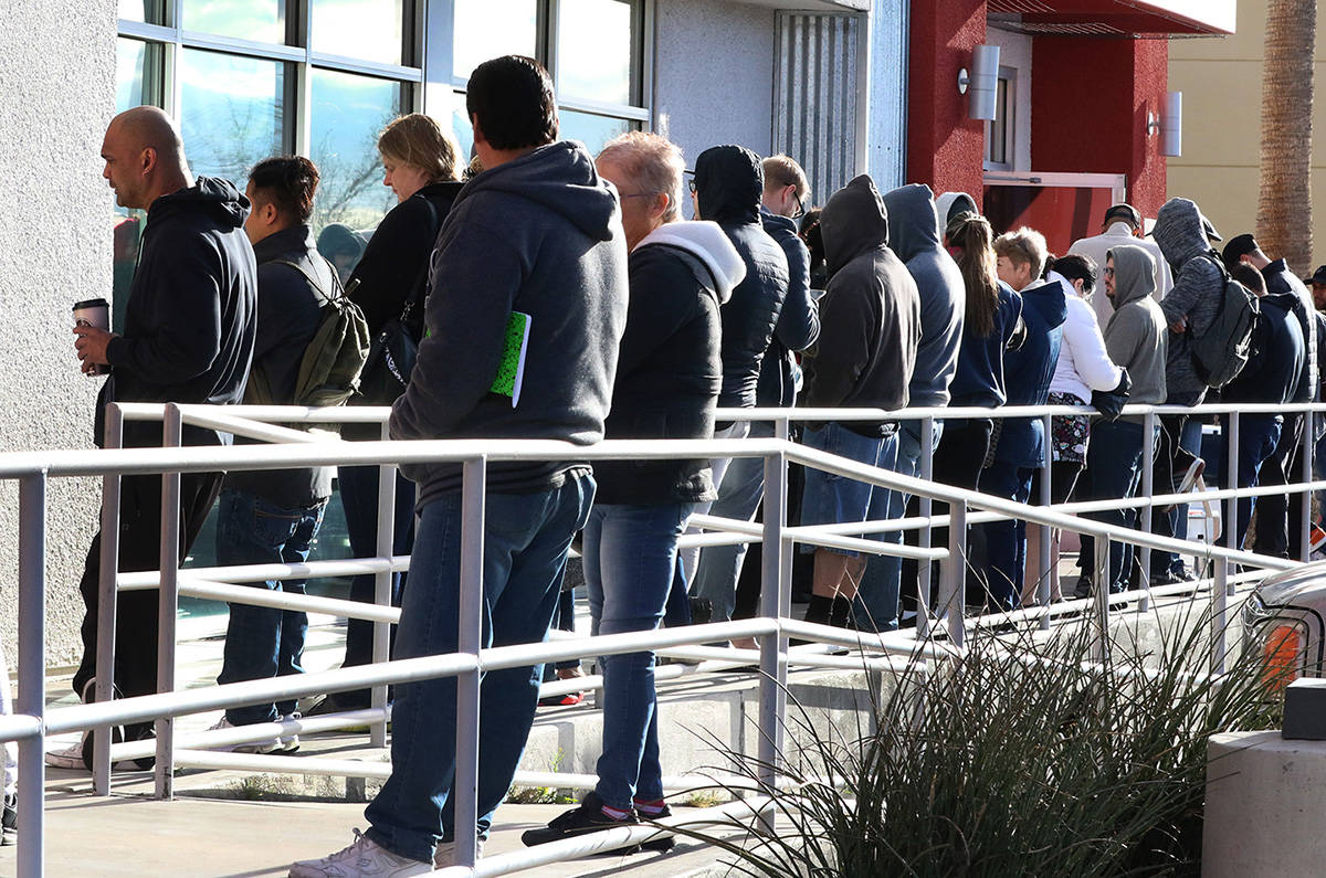 People wait in line at One-Stop Career Center on Tuesday, March 17, 2020, in Las Vegas. (Bizuay ...