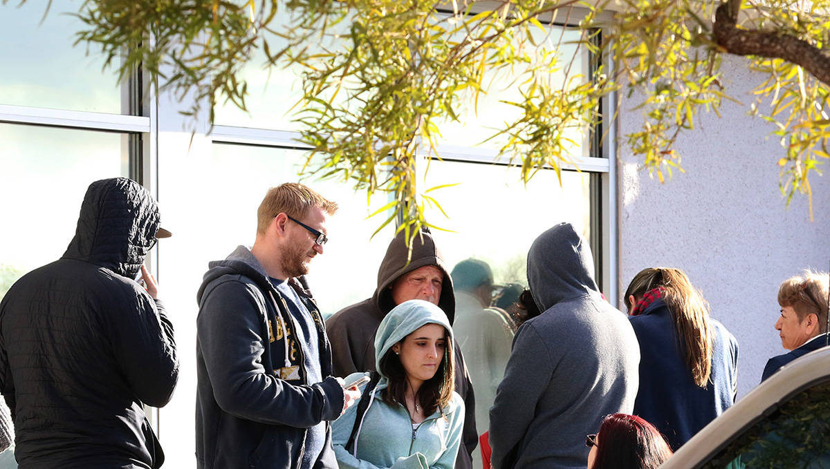 People wait in line at One-Stop Career Center on Tuesday, March 17, 2020, in Las Vegas. (Bizuay ...