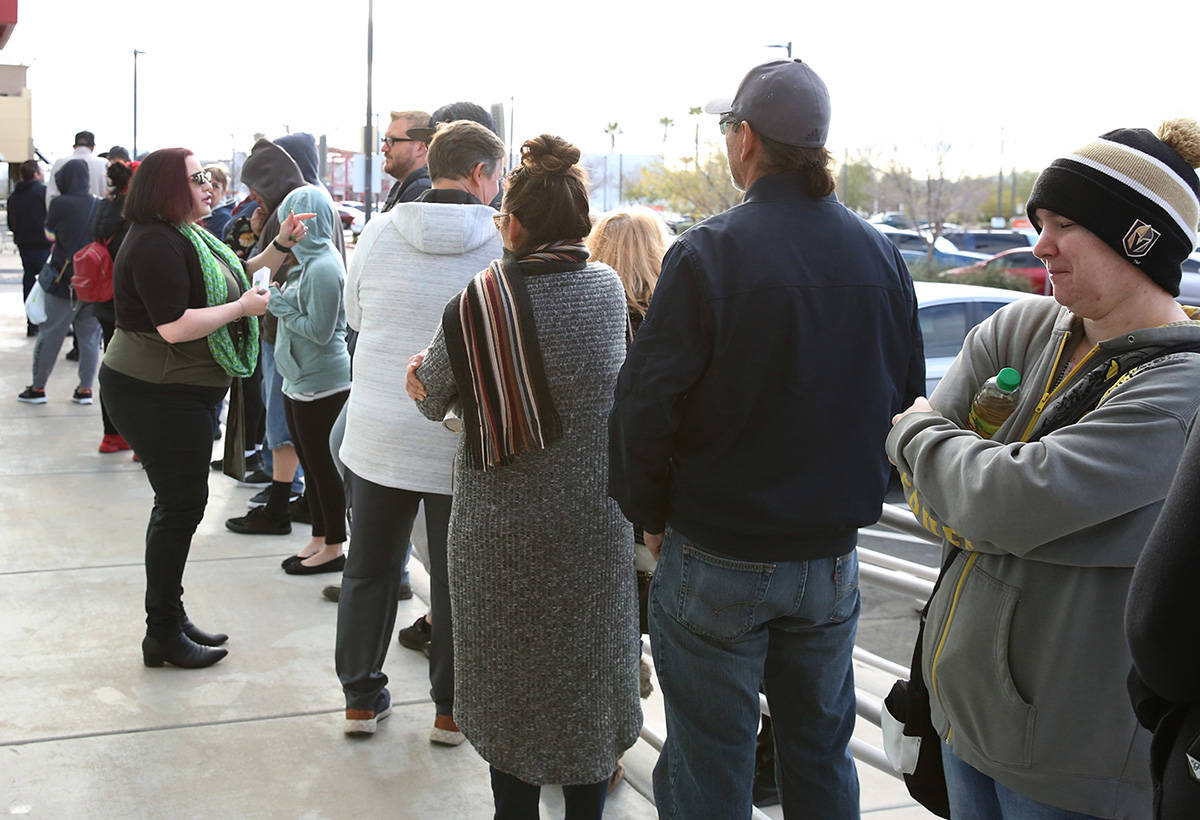 People wait in line at One-Stop Career Center on Tuesday, March 17, 2020, in Las Vegas. (Bizuay ...