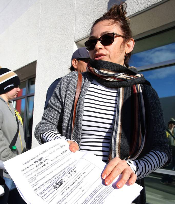 Ana Reyes, 52, former master cook at MGM, holds her layoff letter as she waits in line at One-S ...