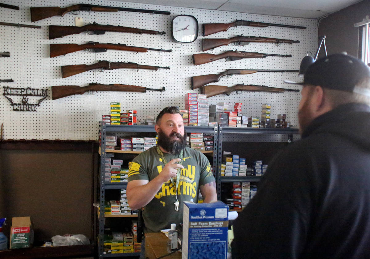 Sales of guns and ammo have been high at Elite Firearms where salesman Joseph Potter assists a ...