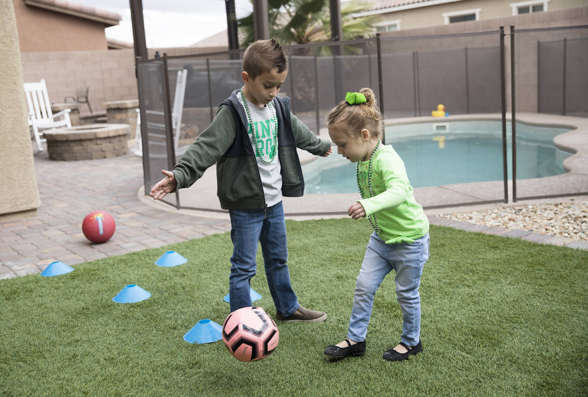 Alex Doleshal, 6, left, plays with his sister, Angie, 3, right, at their home in Henderson, Tue ...