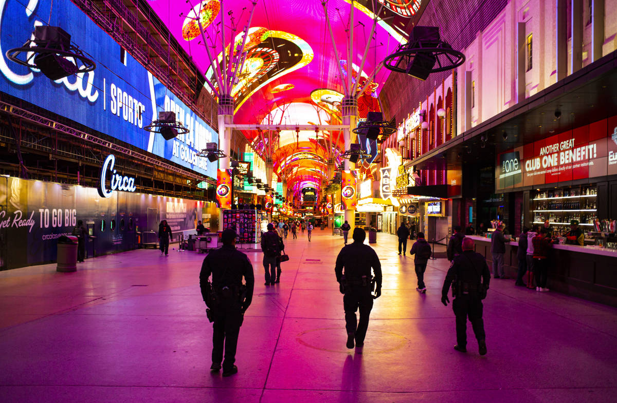 Las Vegas deputy city marshals walk along the Fremont Street Experience following Gov. Steve Si ...