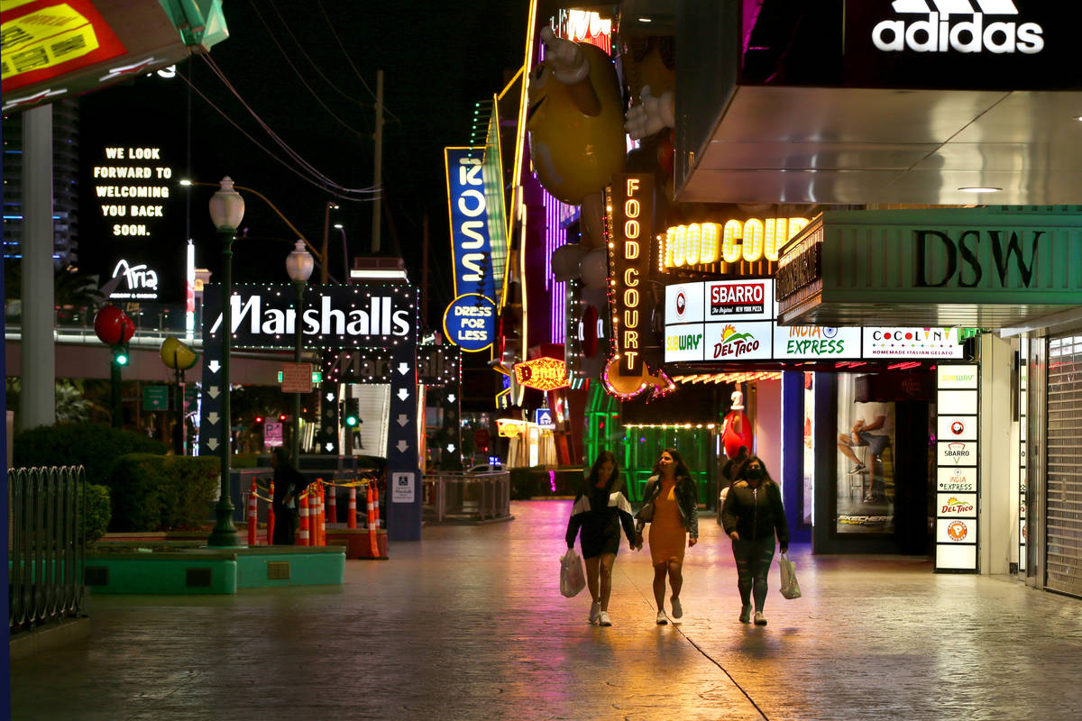 A few pedestrians walk along Las Vegas Boulevard north of the MGM Grand as nonessential busines ...