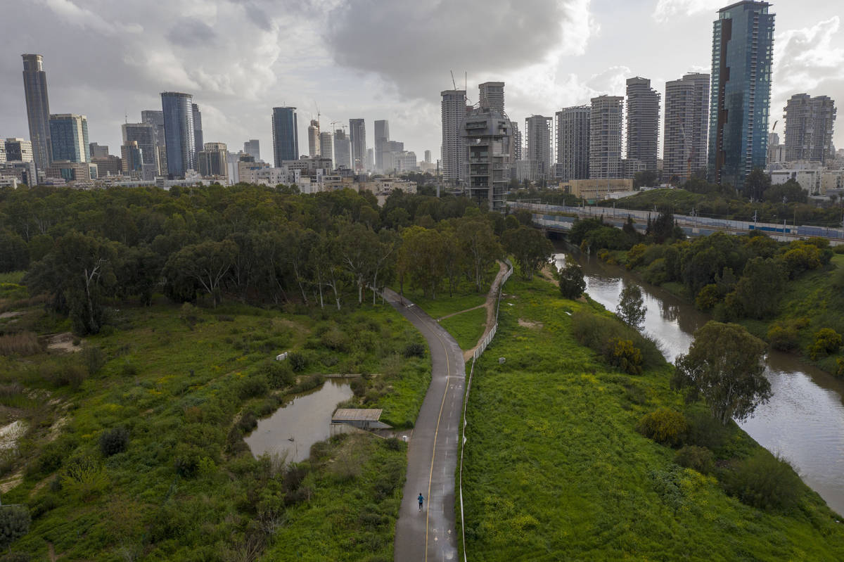 A man runs in a nearly deserted park in Tel Aviv, Israel, Tuesday, March 17, 2020. The head of ...