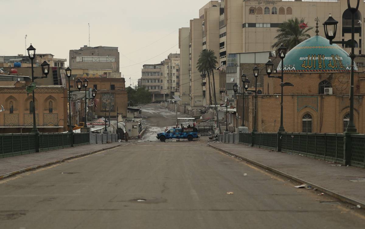 Security forces are deployed in empty streets to impose a curfew in Baghdad, Iraq, Wednesday, M ...