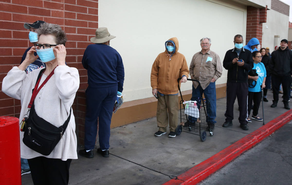 Seniors line up outside a Smith's store on Maryland Parkway on Wednesday, March 18, 2020, in La ...