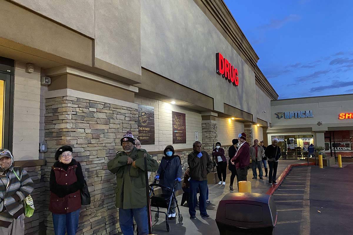 Seniors line up outside a Smith's store on North Rancho Drive on Wednesday, March 18, 2020. (Gl ...