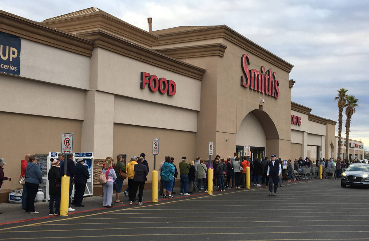 Seniors over 60 line up outside of Smith's in Henderson to get into the grocery store early on ...