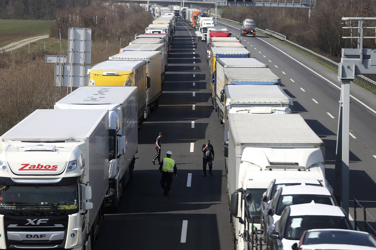 Trucks stand on the highway close to the border between Austria and Hungary near Bruck an der L ...