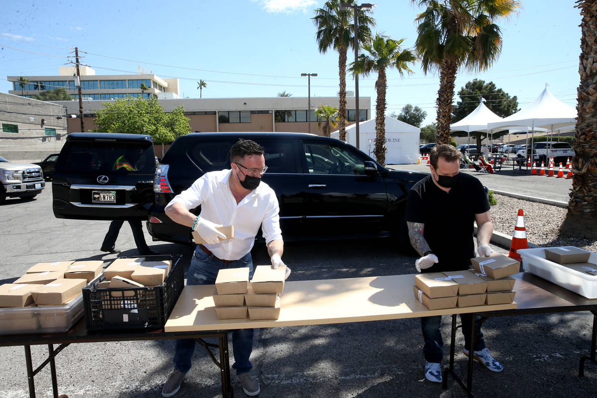 John Anthony, left, and Brian Howard, co-owners of Sparrow + Wolf restaurant, deliver food to p ...
