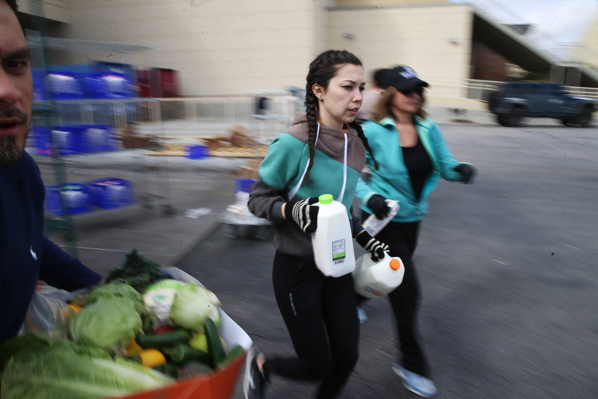 Assistant food and beverage manager Luisa Difalco, center, sprints to car to hand out milk to a ...