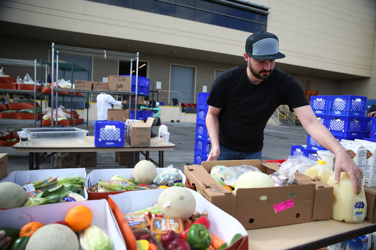 Director of entertainment Justin Teixeira organizes food to be picked up by team members at the ...
