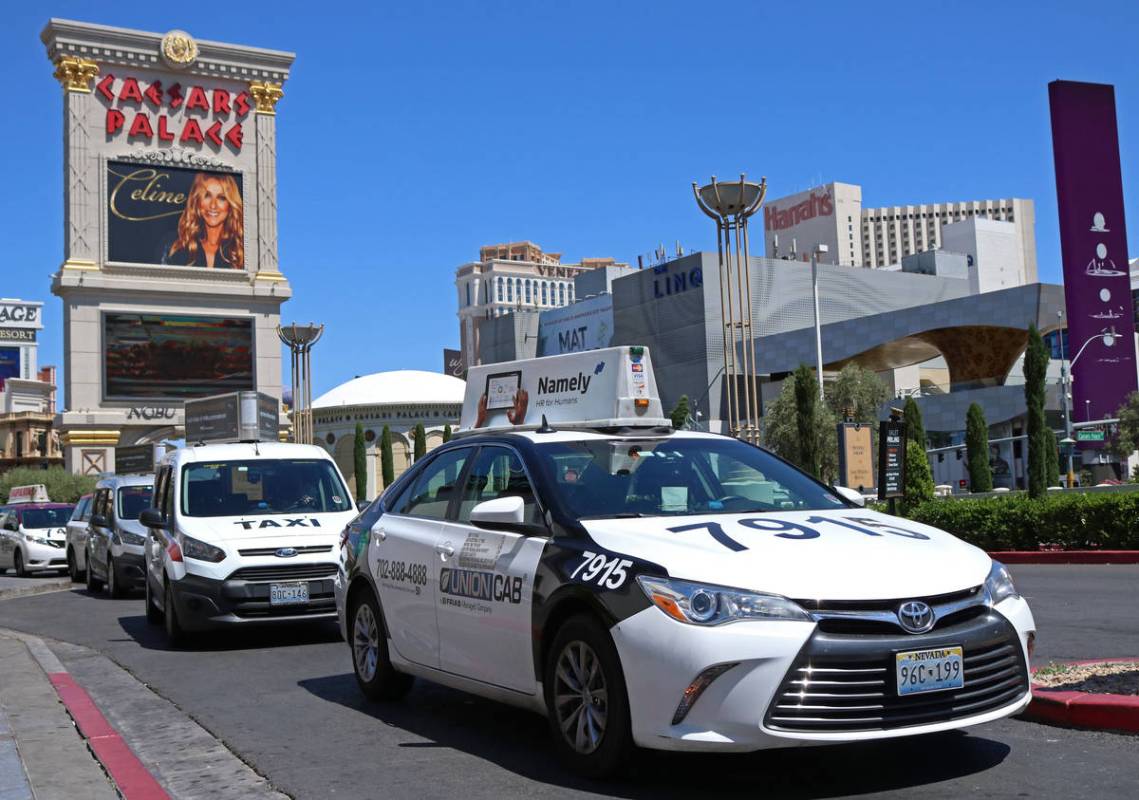 Cab drivers pull into the taxi pick up lane at Caesars Palace in Las Vegas, Thursday, April 20, ...