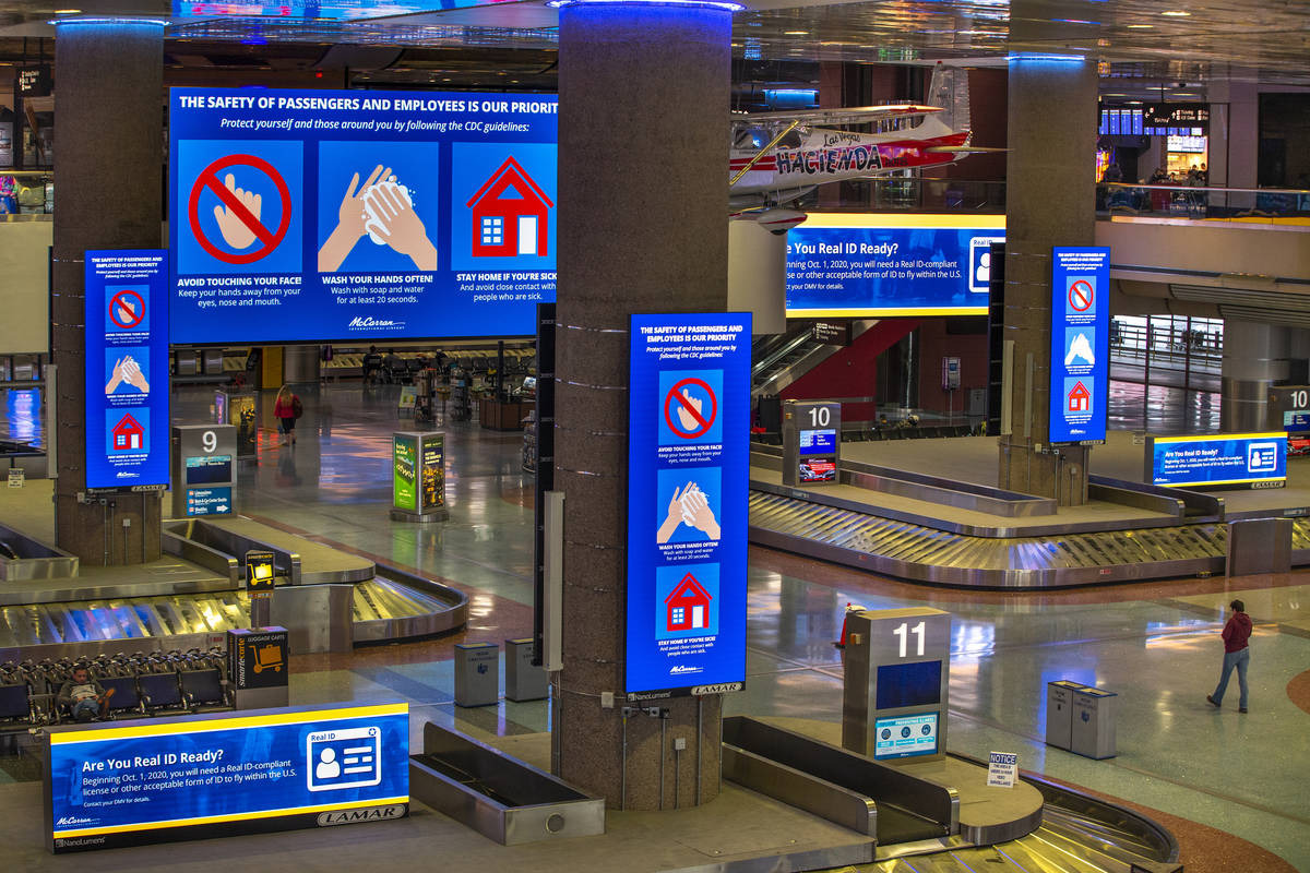 Safety messages are displayed to passengers and employees in the baggage area in Terminal 1 at ...