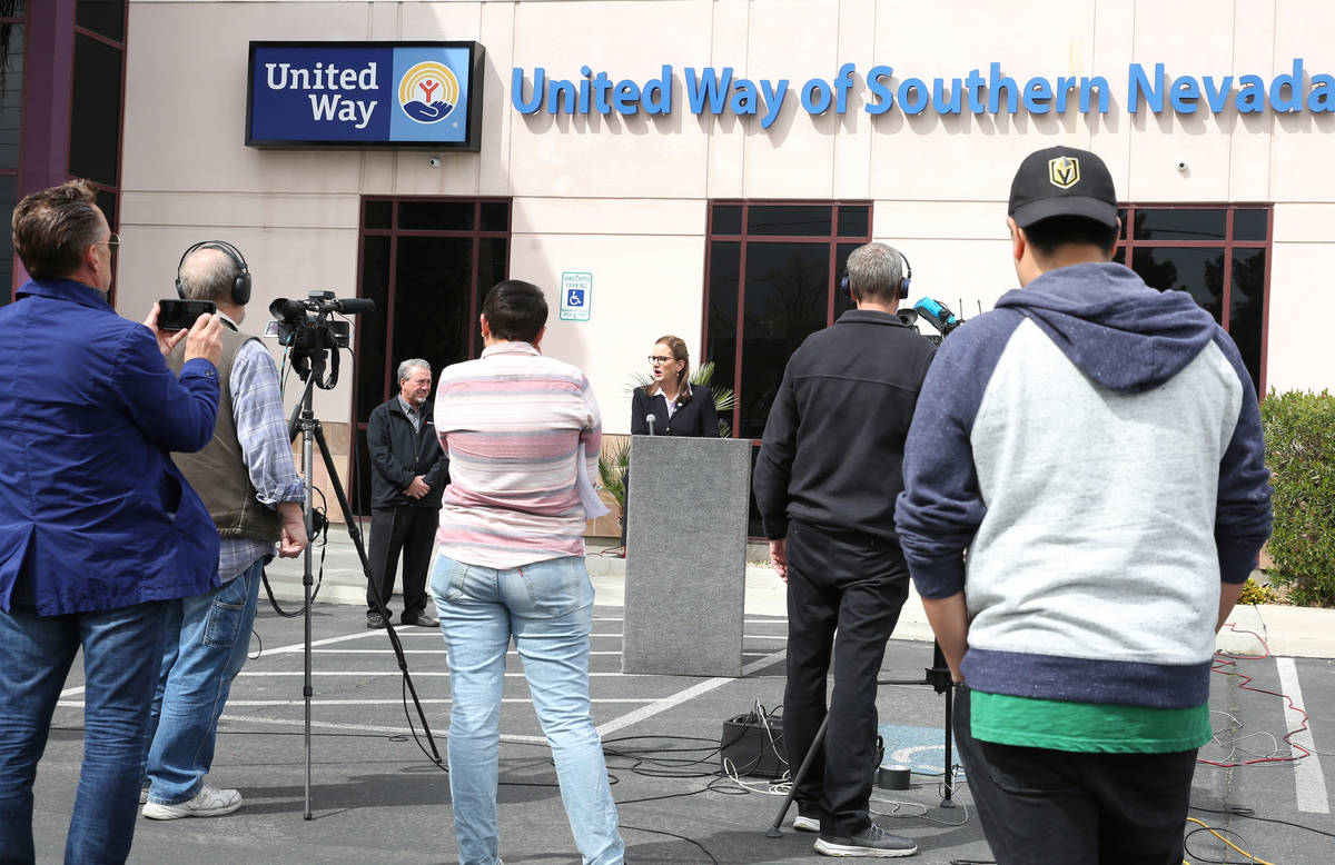 United Way Southern Nevada President and CEO Kyle Rahn, center, speaks as Tony Sanchez, third l ...