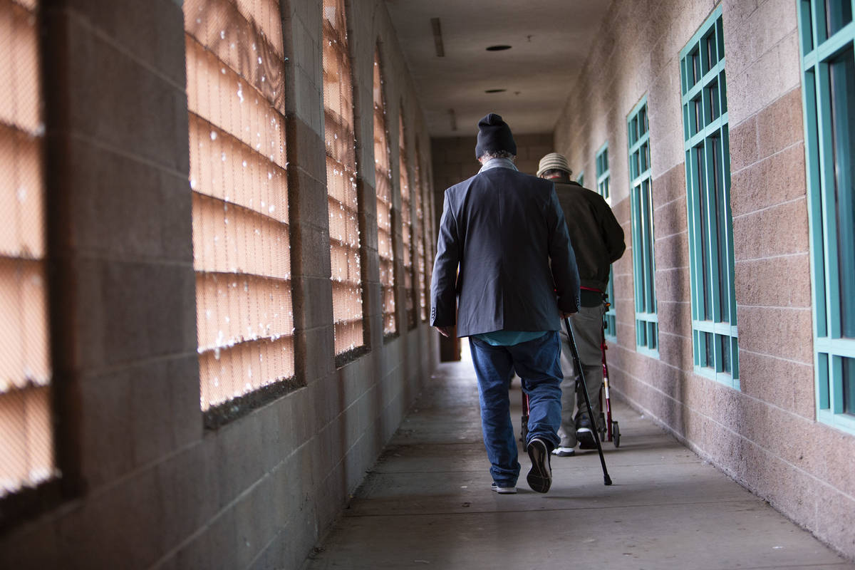 People exit Catholic Charities after having the free Christmas Day meal on Wednesday, Dec. 25, ...