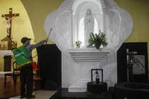 A worker disinfects a Catholic church amid fears of the new coronavirus outbreak in Yogyakarta, ...