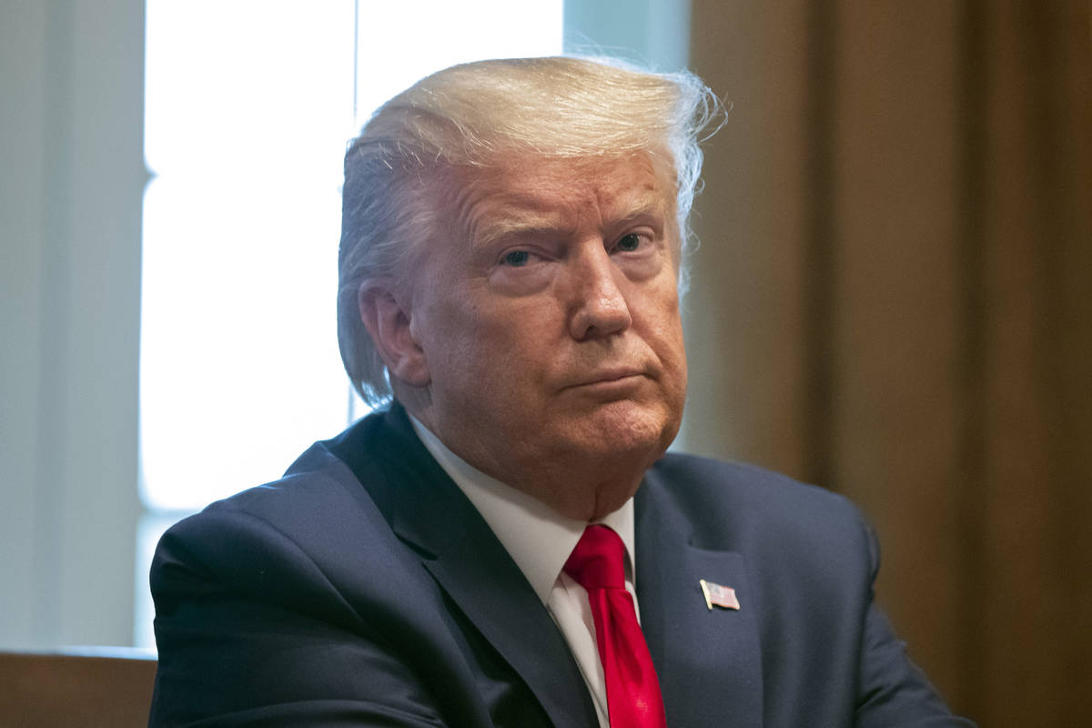 President Donald Trump listens as others speak about the coronavirus in the Cabinet Room of the ...