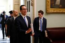 Treasury Secretary Steve Mnuchin asks members of the media to practice social distancing as he ...