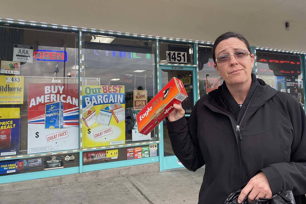 Amy Brown of Las Vegas holds a carton of cigarettes she bought at The Smoke Shop, 1451 Jones Bl ...