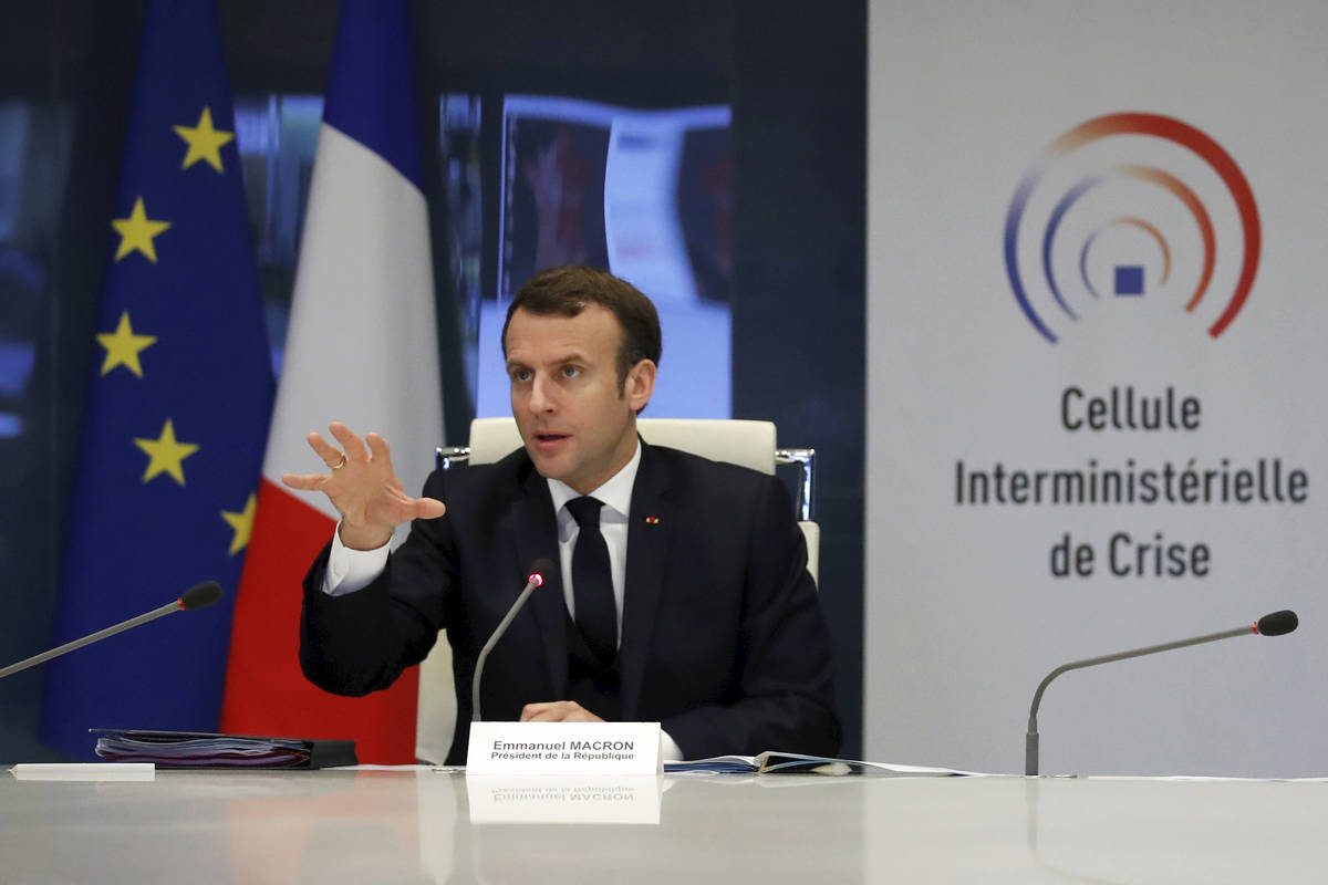 French President Emmanuel Macron attends a meeting at the emergency crisis center of the Interi ...