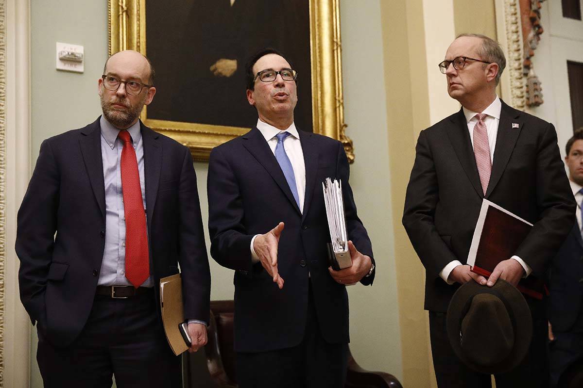 Treasury Secretary Steve Mnuchin, center, speaks with members of the media as he departs a meet ...