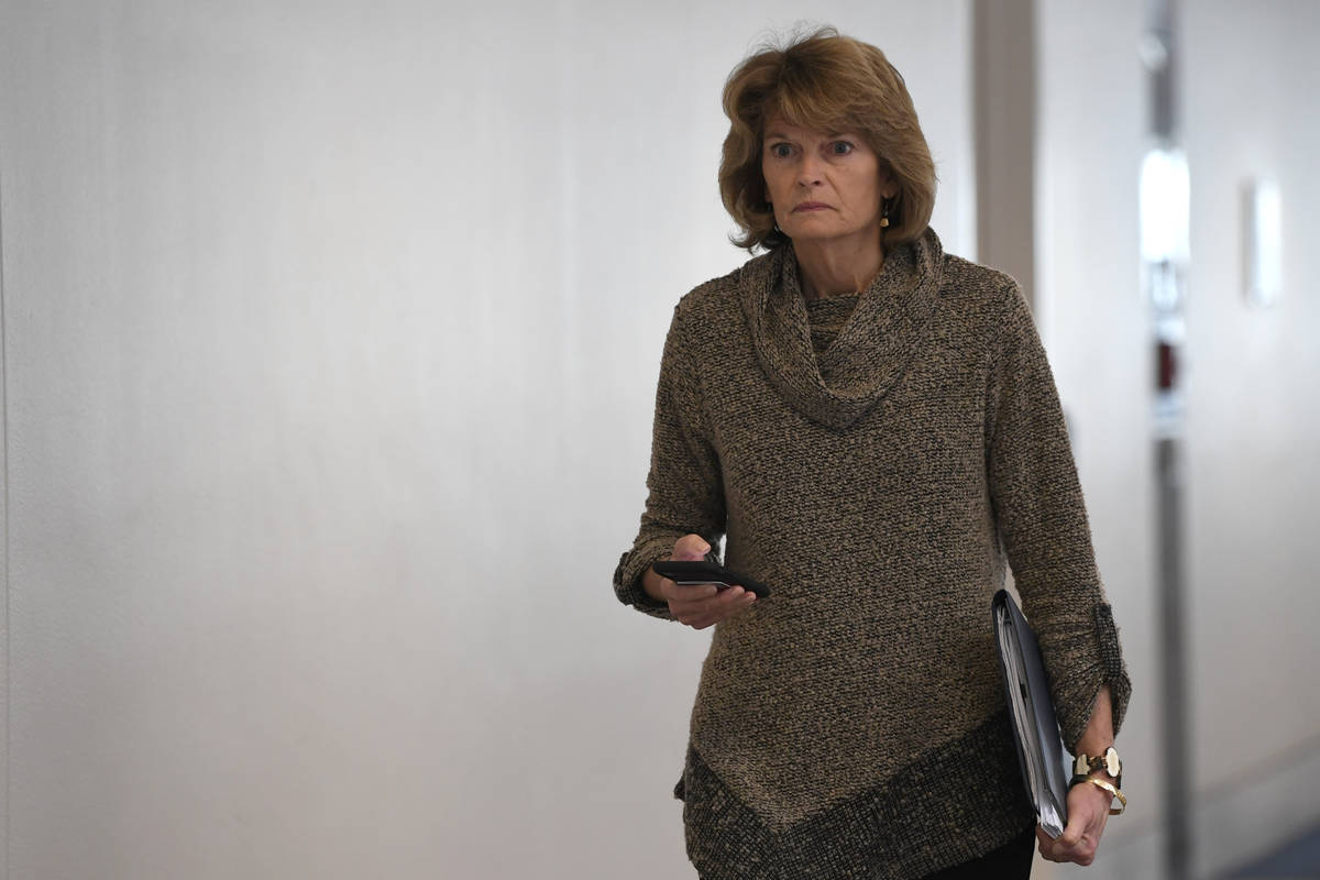 Sen. Lisa Murkowski, R-Alaska, heads into a Republican policy lunch on Capitol Hill in Washingt ...