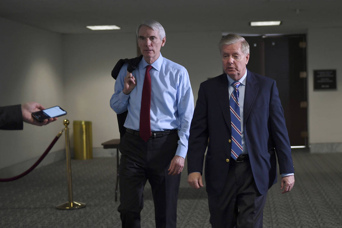 Sen. Rob Portman, R-Ohio,, left, and Sen. Lindsey Graham, R-S.C., right, leave a Republican pol ...