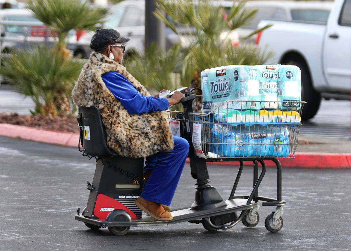 A woman, who declined to give her name, visiting from Oakland, Calif., drives her electric scoo ...