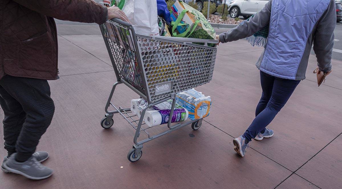 Seniors leave with the limited amount of water and toilet paper per house permitted from a Smit ...