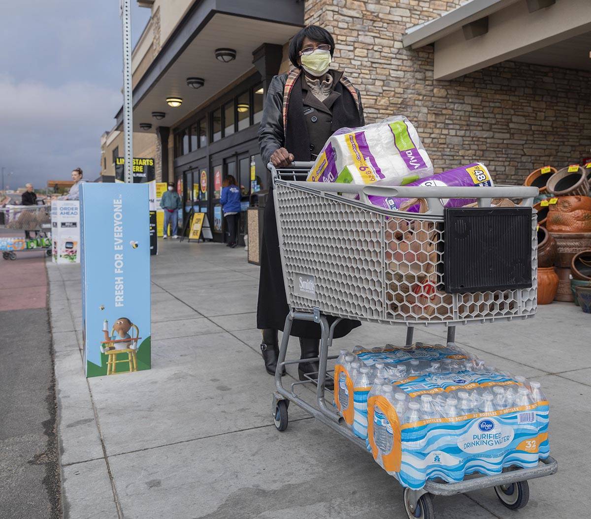 Terry Arthur, 71, of Las Vegas, exits with the limited amount of water and toilet paper per hou ...