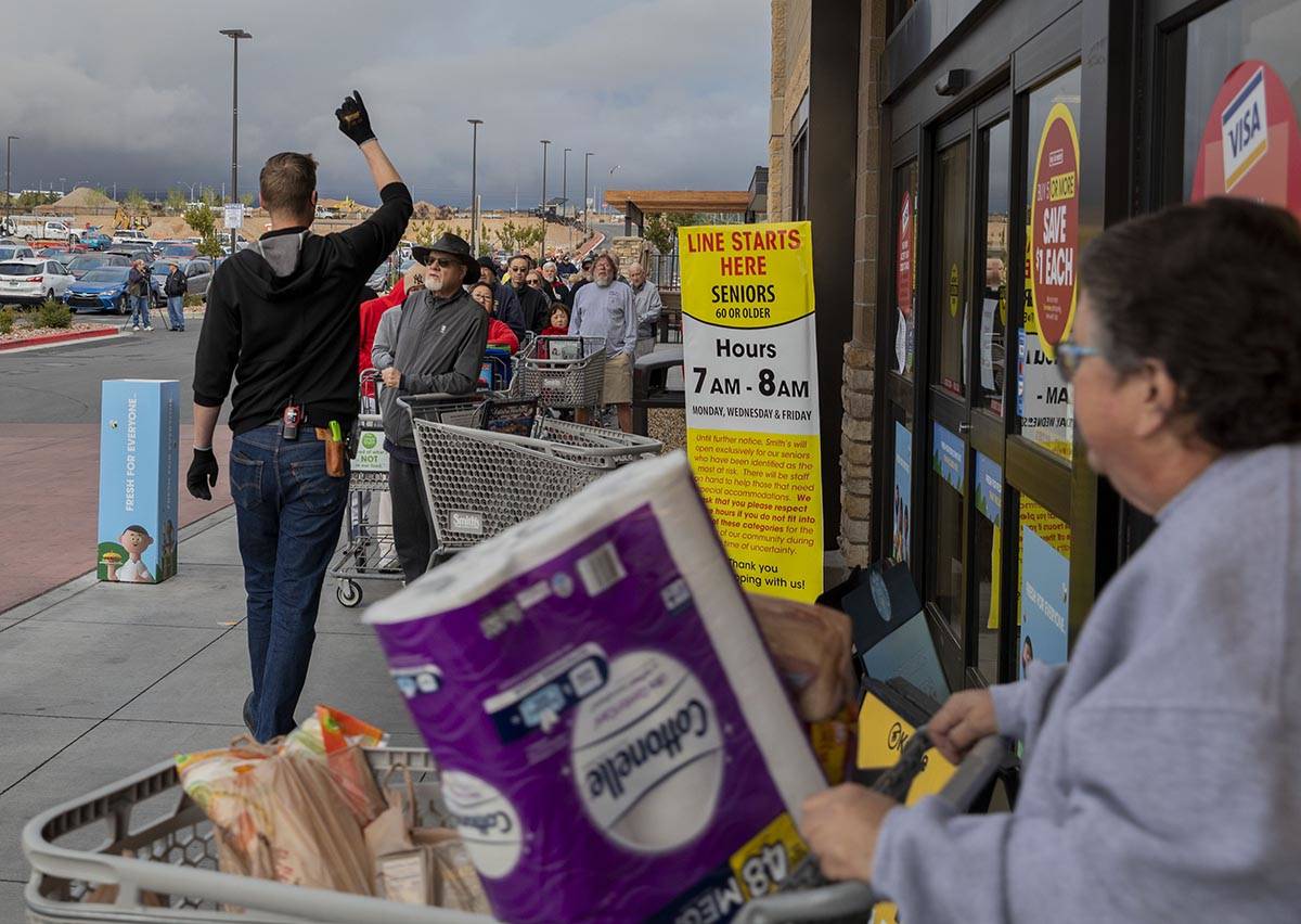 Instructions on limited items are given to the line of seniors out of a Smith's Marketplace loc ...